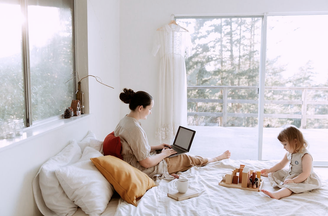 Home-based lady working on her bed