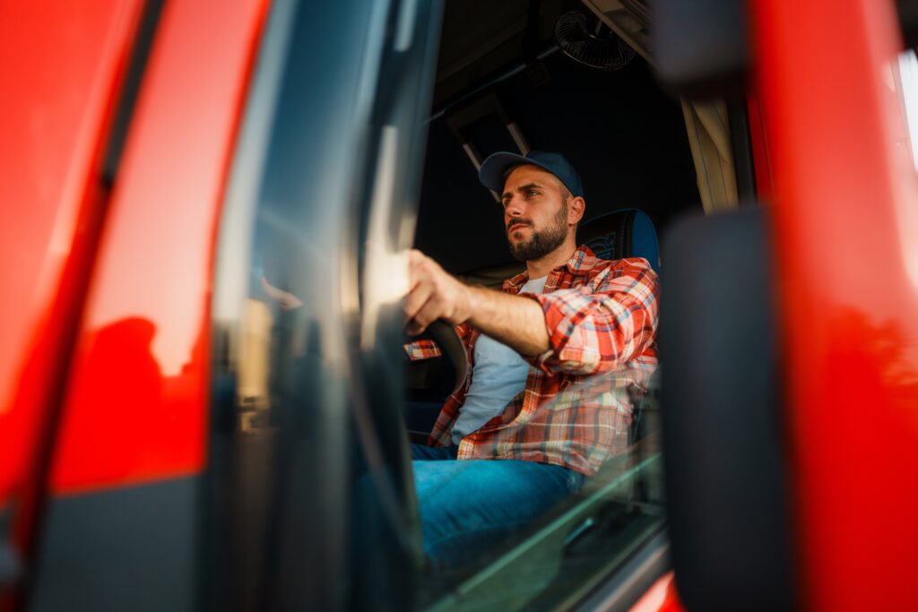 man with truck driving business in his red transfer truck
