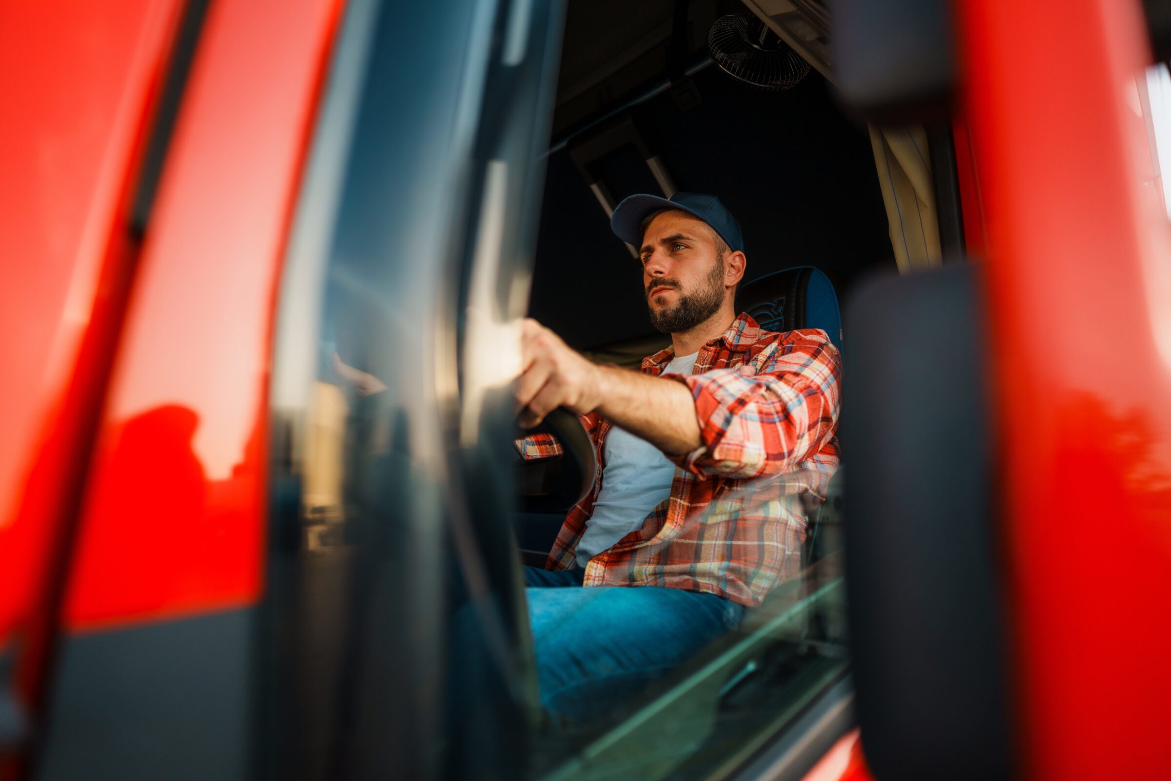 man with truck driving business in his red transfer truck
